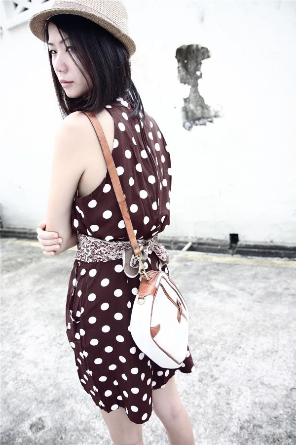 1980s polka dot romper tied at the waist with a scarf; 1980s leather Dooney and Bourke sling bag