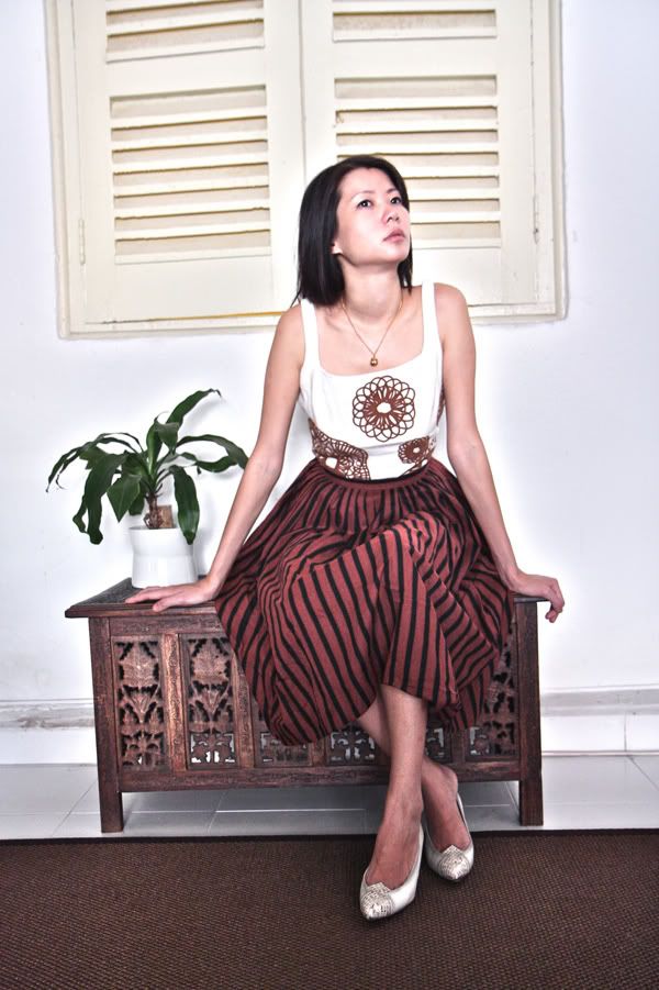 Sit pretty in a 1980s embroidered top, 1950s striped skirt with 80s snakeskin pumps